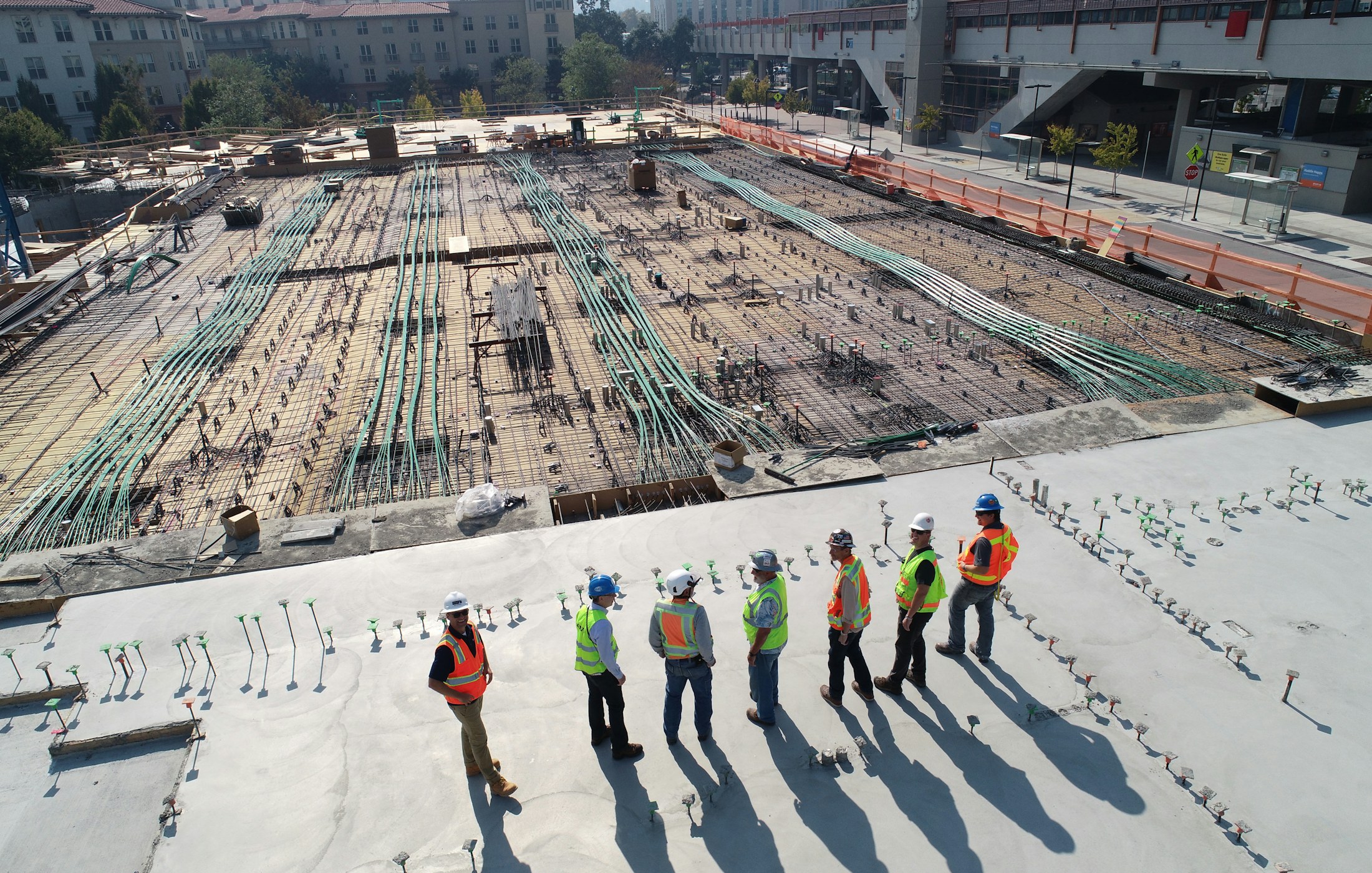 Construction professionals overlooking an active commercial jobsite